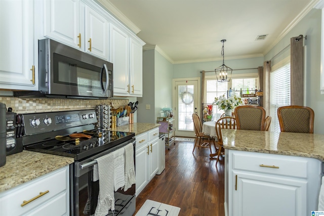 1120 Weybridge Way, Pelham, AL 35124 - kitchen featuring black electric range oven, stainless steel microwave, crown molding, backsplash, and white cabinetry