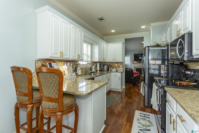 1120 Weybridge Way, Pelham, AL 35124 - kitchen with range with electric stovetop, stainless steel microwave, a peninsula, backsplash, and recessed lighting