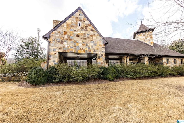 1120 Weybridge Way, Pelham, AL 35124 - back of house with stone siding, a lawn, a shingled roof, and a chimney