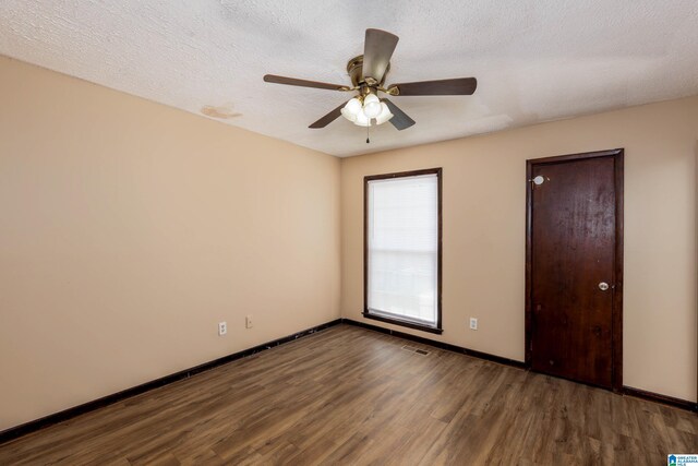 2517 Wright Cir, Birmingham, AL 35235 - unfurnished bedroom with wood finished floors, ceiling fan, and a textured ceiling