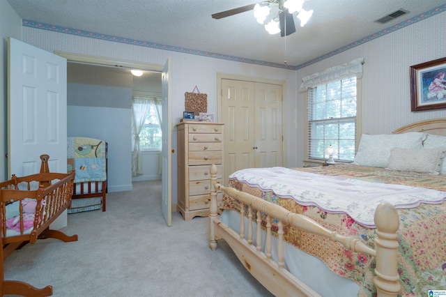 3518 William And Mary Rd, Hoover, AL 35216 - carpeted bedroom with a closet, a textured ceiling, a ceiling fan, and wallpapered walls