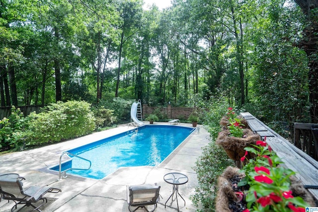 3518 William And Mary Rd, Hoover, AL 35216 - view of swimming pool featuring a water slide, a patio area, and a diving board