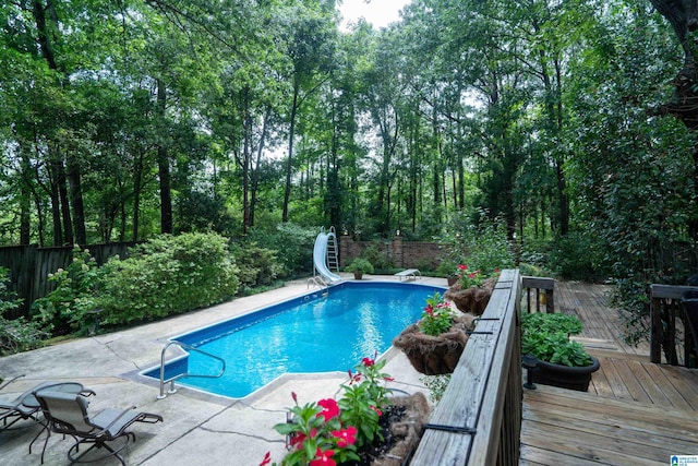 3518 William And Mary Rd, Hoover, AL 35216 - view of swimming pool with a water slide, a fenced backyard, a deck, a diving board, and a patio area