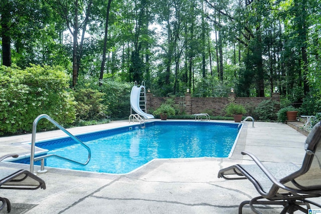 3518 William And Mary Rd, Hoover, AL 35216 - view of swimming pool with a water slide, a patio area, and view of scattered trees