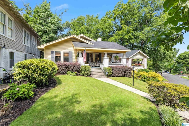620 S 52nd St, Birmingham, AL 35212 - view of front facade featuring covered porch, a front lawn, and a chimney