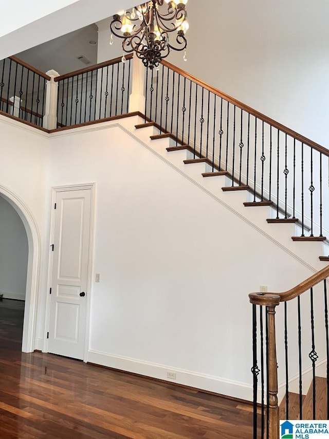 1664 Warren Ln, Vestavia Hills, AL 35243 - stairs featuring arched walkways, wood finished floors, and a chandelier