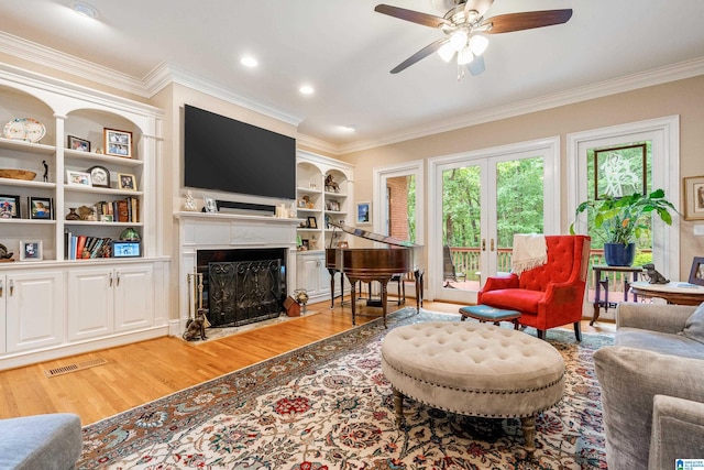 1007 Eagle Hill Dr, Birmingham, AL 35242 - living area featuring light wood-style floors, a fireplace with flush hearth, crown molding, a ceiling fan, and built in shelves