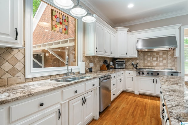 1007 Eagle Hill Dr, Birmingham, AL 35242 - kitchen with wall chimney exhaust hood, appliances with stainless steel finishes, tasteful backsplash, crown molding, and light wood-style flooring