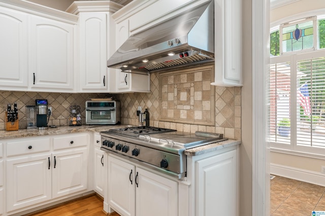 1007 Eagle Hill Dr, Birmingham, AL 35242 - kitchen with exhaust hood, stainless steel gas cooktop, decorative backsplash, and white cabinets