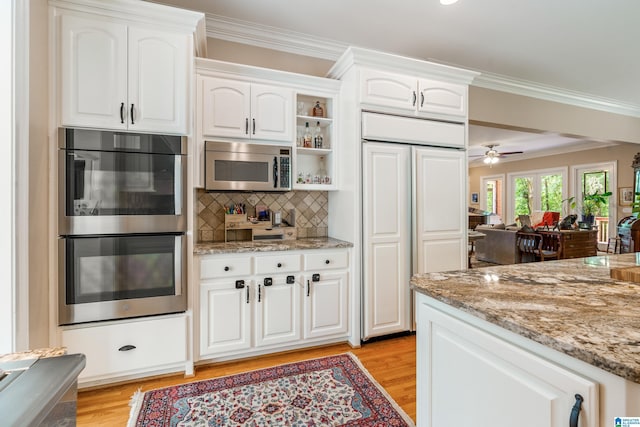 1007 Eagle Hill Dr, Birmingham, AL 35242 - kitchen featuring appliances with stainless steel finishes, ornamental molding, light wood finished floors, and light stone countertops
