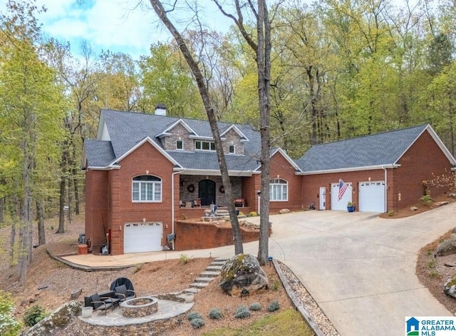 1007 Eagle Hill Dr, Birmingham, AL 35242 - view of front of house featuring an outdoor fire pit, driveway, a chimney, and a shingled roof