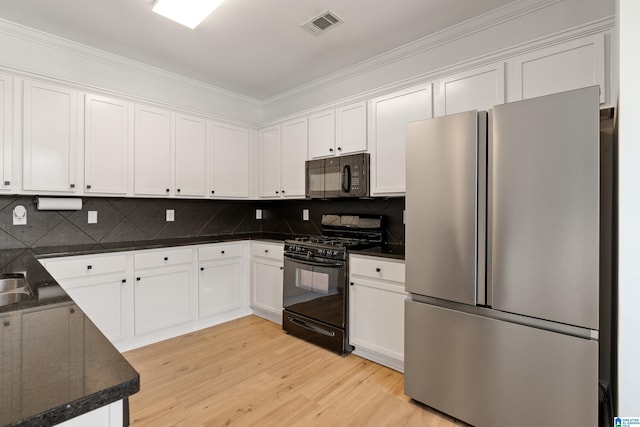 1185 Overlook Dr, Trussville, AL 35173 - kitchen featuring black appliances, light wood-style floors, white cabinetry, backsplash, and ornamental molding