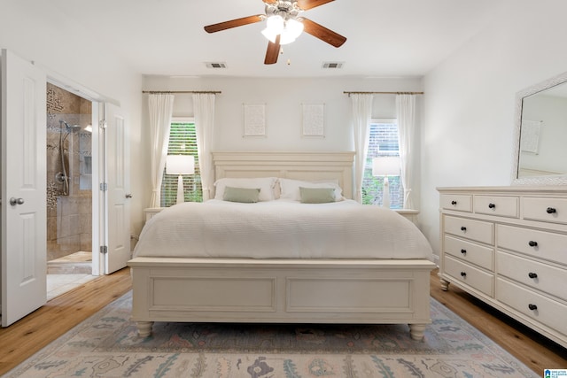 1185 Overlook Dr, Trussville, AL 35173 - bedroom with wood finished floors, ensuite bath, and ceiling fan