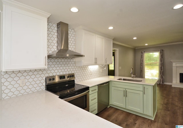 7101 Cavern Rd, Trussville, AL 35173 - kitchen featuring wall chimney exhaust hood, stainless steel appliances, green cabinets, a peninsula, and light countertops