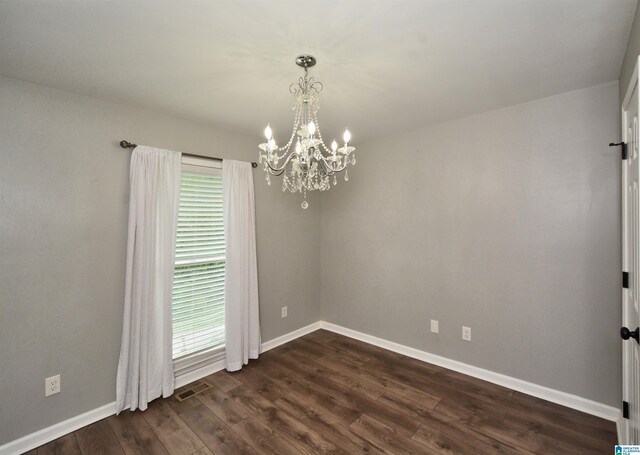7101 Cavern Rd, Trussville, AL 35173 - spare room with a chandelier, healthy amount of natural light, and dark wood-type flooring