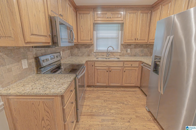 2191 Whiting Rd, Hoover, AL 35216 - kitchen featuring appliances with stainless steel finishes, light wood-style floors, tasteful backsplash, light stone countertops, and light brown cabinets