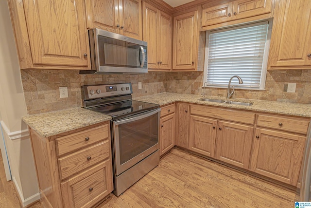 2191 Whiting Rd, Hoover, AL 35216 - kitchen with stainless steel appliances, backsplash, light wood-type flooring, light stone countertops, and light brown cabinets