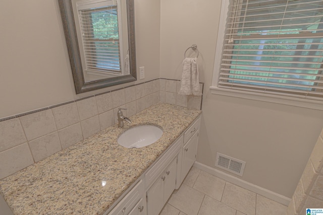 2191 Whiting Rd, Hoover, AL 35216 - bathroom with vanity, tile patterned floors, and backsplash