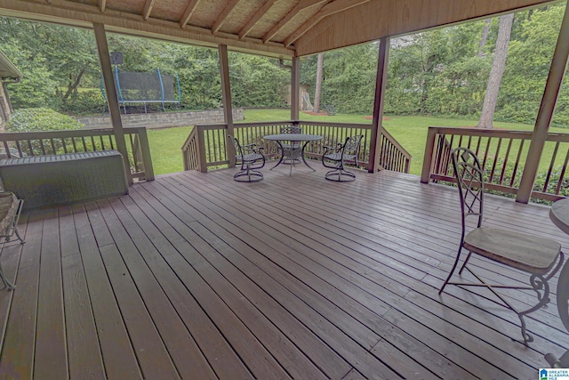 2191 Whiting Rd, Hoover, AL 35216 - wooden terrace with a trampoline, a yard, and outdoor dining space