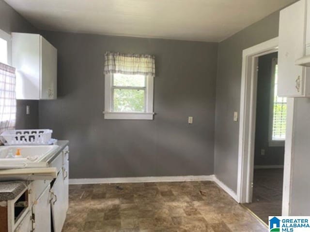 209 61st St, Fairfield, AL 35064 - washroom with baseboards and stone finish flooring