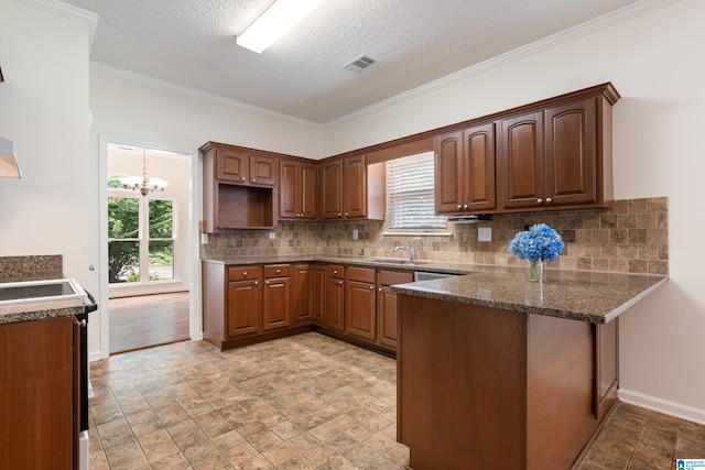 313 Chadwick Pl, Helena, AL 35080 - kitchen featuring a peninsula, stone finish flooring, decorative backsplash, a chandelier, and ornamental molding