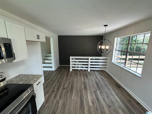 8312 Country Cir, Pinson, AL 35126 - unfurnished dining area with dark wood-type flooring, a chandelier, and an accent wall