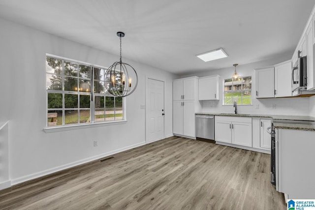 8312 Country Cir, Pinson, AL 35126 - kitchen featuring appliances with stainless steel finishes, light wood-style flooring, a chandelier, white cabinets, and hanging light fixtures