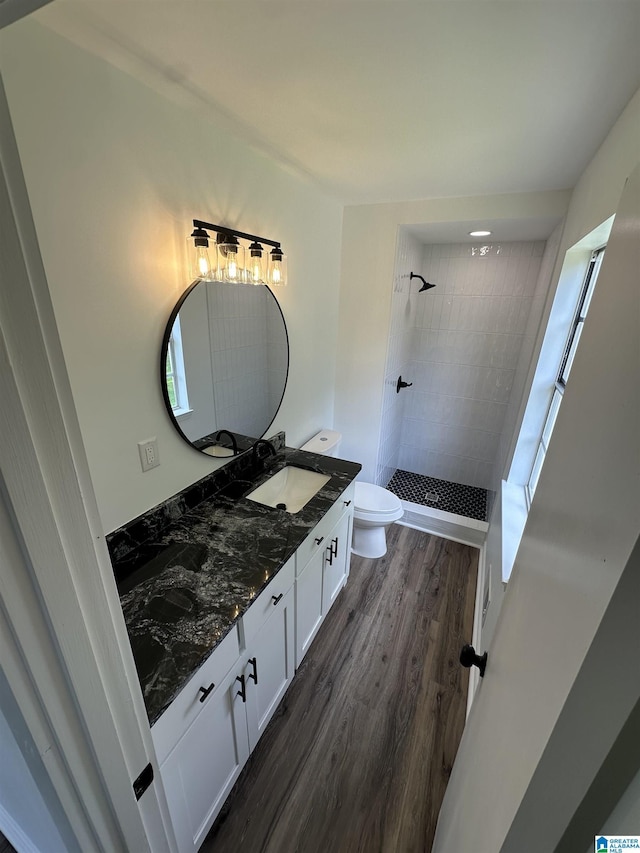 8312 Country Cir, Pinson, AL 35126 - bathroom with tiled shower, double vanity, and wood finished floors