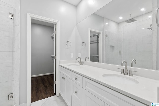 4652 Lake Valley Dr, Hoover, AL 35244 - bathroom with a walk in closet, a stall shower, double vanity, and tile patterned floors