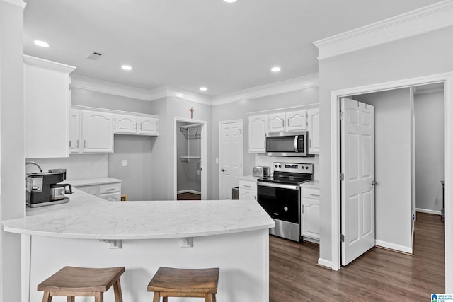 4652 Lake Valley Dr, Hoover, AL 35244 - kitchen with stainless steel appliances, a peninsula, white cabinetry, dark wood finished floors, and crown molding