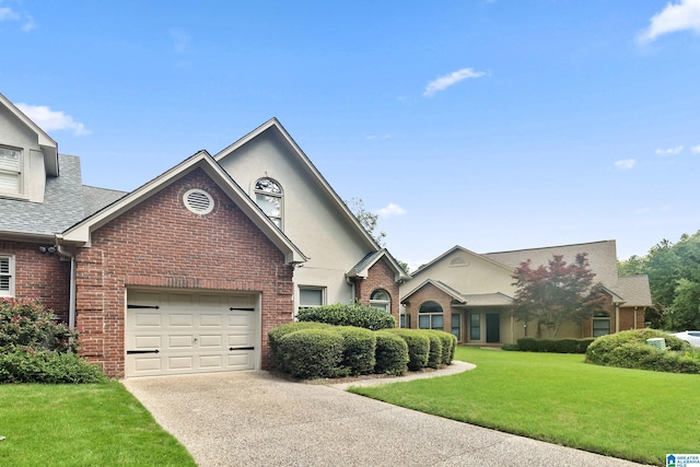 4652 Lake Valley Dr, Hoover, AL 35244 - view of front facade featuring a front lawn, brick siding, concrete driveway, an attached garage, and roof with shingles