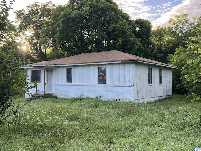 3019 7th Ave N, Bessemer, AL 35020 - view of side of property with brick siding, a shingled roof, and a lawn