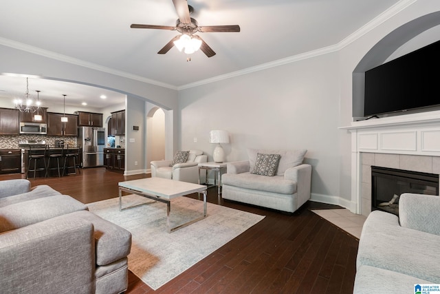 5432 Parkside Cir, Hoover, AL 35244 - living area featuring ornamental molding, arched walkways, dark wood-type flooring, a ceiling fan, and a tile fireplace