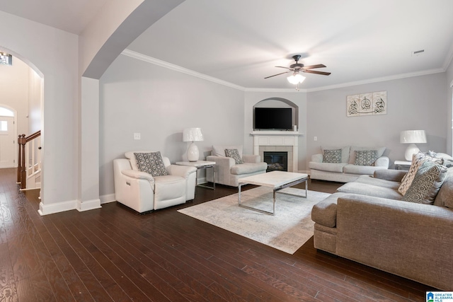 5432 Parkside Cir, Hoover, AL 35244 - living area with ceiling fan, arched walkways, a tiled fireplace, crown molding, and dark wood finished floors