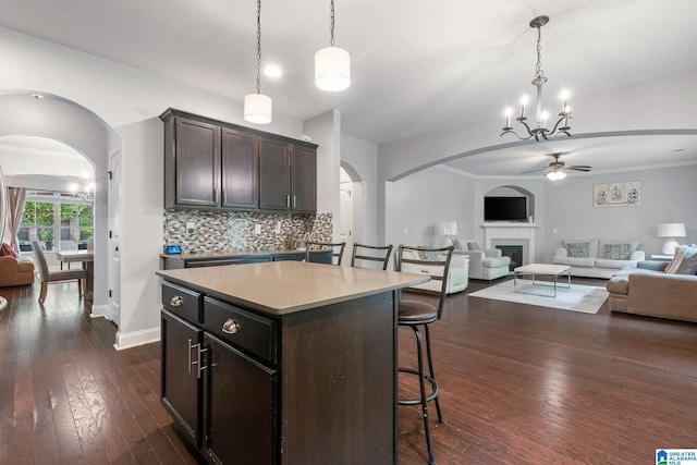 5432 Parkside Cir, Hoover, AL 35244 - kitchen featuring open floor plan, a ceiling fan, arched walkways, a breakfast bar area, and tasteful backsplash