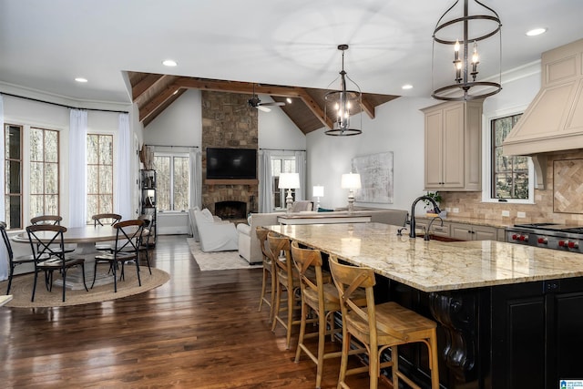 6902 Honor Keith Rd, Trussville, AL 35173 - kitchen with custom range hood, light stone counters, ceiling fan, a large fireplace, and dark wood-style floors