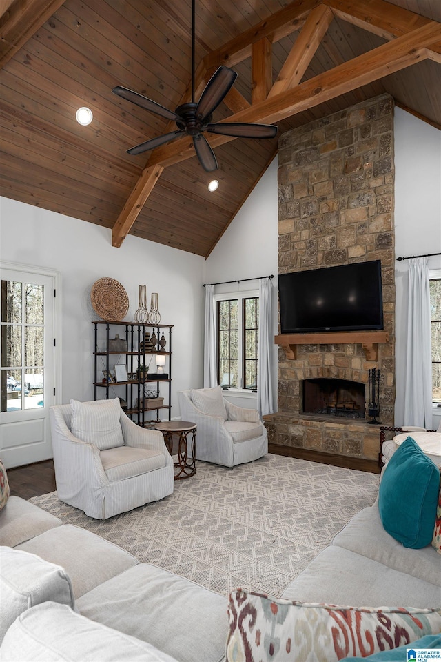 6902 Honor Keith Rd, Trussville, AL 35173 - living area featuring a wooden ceiling with exposed beams, ceiling fan, wood finished floors, healthy amount of natural light, and a stone fireplace