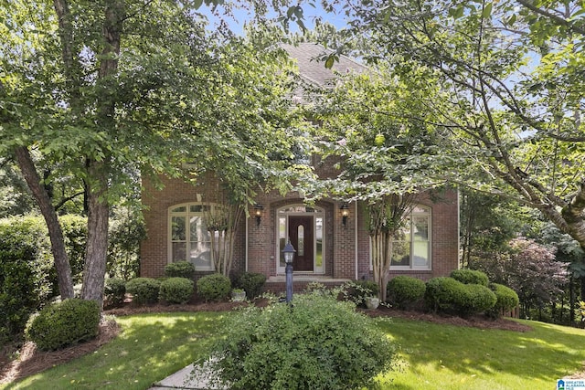 5521 Magnolia Trce, Hoover, AL 35244 - view of property hidden behind natural elements featuring a front lawn and brick siding