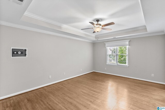 5521 Magnolia Trce, Hoover, AL 35244 - spare room with a raised ceiling, light wood-style floors, ceiling fan, and ornamental molding