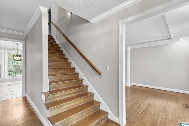 5521 Magnolia Trce, Hoover, AL 35244 - stairway featuring ornamental molding, wood finished floors, and a chandelier