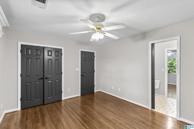 5521 Magnolia Trce, Hoover, AL 35244 - unfurnished bedroom with wood finished floors, a closet, and a ceiling fan