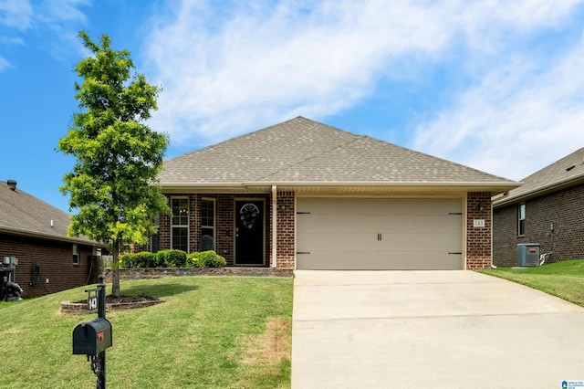 143 Hidden Trace Ct, Montevallo, AL 35115 - view of front facade with brick siding, a garage, driveway, and a front lawn
