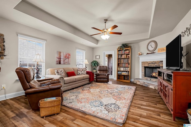 143 Hidden Trace Ct, Montevallo, AL 35115 - living room with a tray ceiling, ceiling fan, a fireplace, and wood finished floors