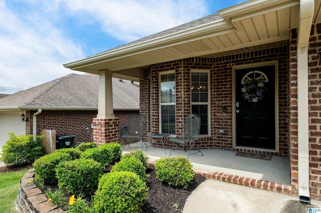 143 Hidden Trace Ct, Montevallo, AL 35115 - entrance to property featuring brick siding, a shingled roof, a porch, and a garage