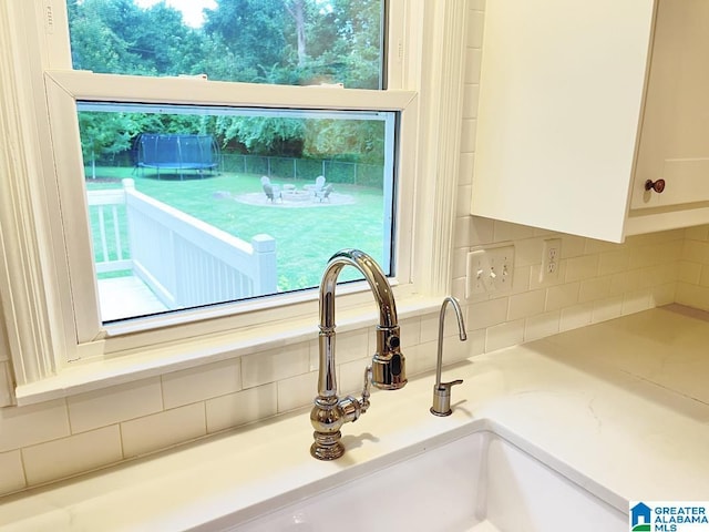 2713 Altadena Lake Rd, Birmingham, AL 35243 - kitchen view of tasteful backsplash, white cabinets, and light countertops