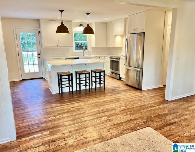 2713 Altadena Lake Rd, Birmingham, AL 35243 - kitchen with appliances with stainless steel finishes, light wood-style floors, plenty of natural light, a center island, and recessed lighting