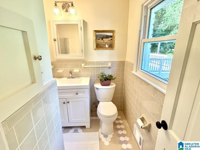 2713 Altadena Lake Rd, Birmingham, AL 35243 - half bath with tile walls, vanity, wainscoting, and tile patterned floors