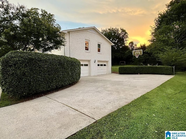 2713 Altadena Lake Rd, Birmingham, AL 35243 - property exterior at dusk featuring driveway, a garage, and a yard