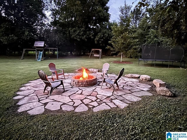 2713 Altadena Lake Rd, Birmingham, AL 35243 - view of patio / terrace with a trampoline, a fire pit, and view of wooded area