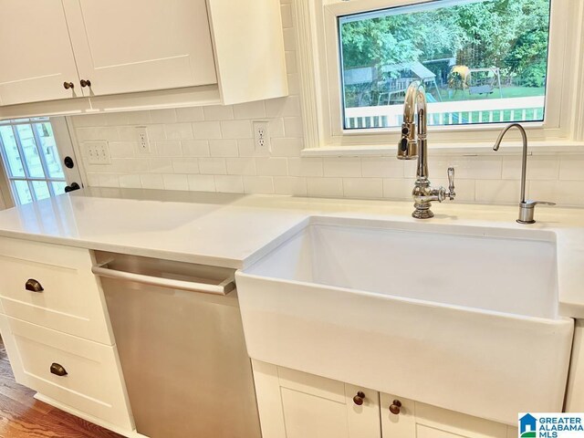 2713 Altadena Lake Rd, Birmingham, AL 35243 - kitchen featuring dishwasher, backsplash, white cabinets, light countertops, and wood finished floors